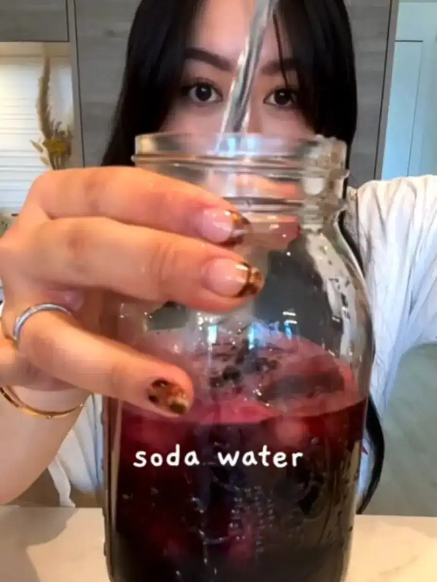 Adding Soda Water to blueberry jam for healthy fizzy Blueberry Chia Drink