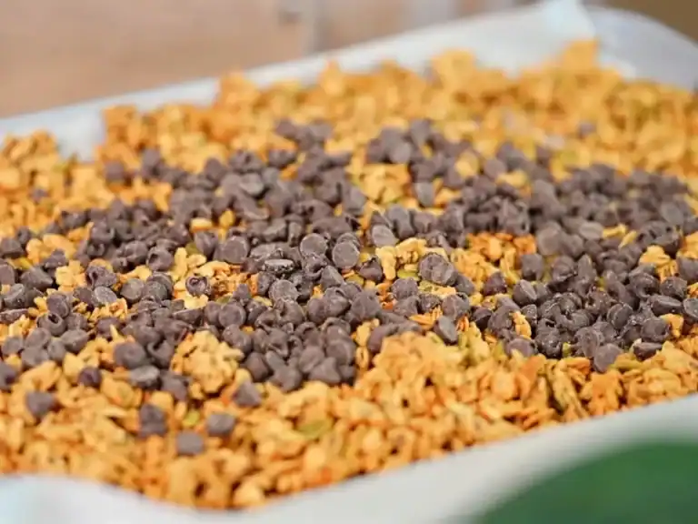 Freshly made homemade granola with chocolate chips, peanut butter and maple syrup