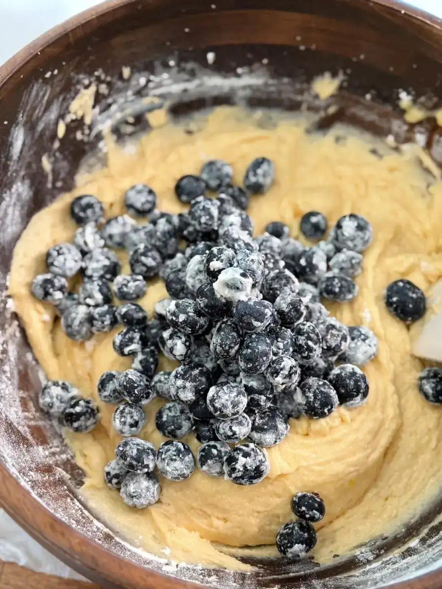 Mixing blueberries into the batter