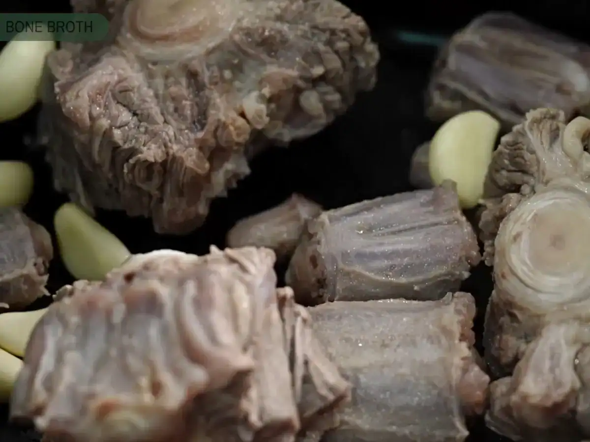 Adding garlic and blanched oxtail into a pot to make Korean Oxtail Soup
