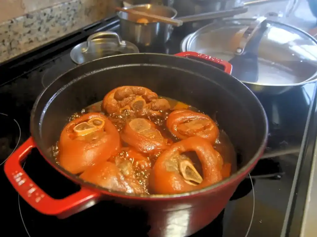 Mom’s birthday dinner - pork knuckle soup braising in a pot 