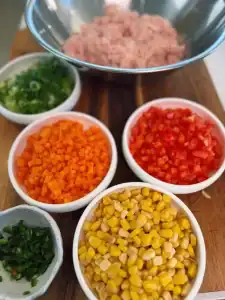 Chopped vegetables mixed into Spicy Chicken Veggie Patties