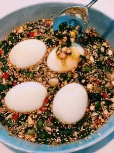 Pouring marinade over freshly boiled egg for Marinated Korean Mayak Eggs