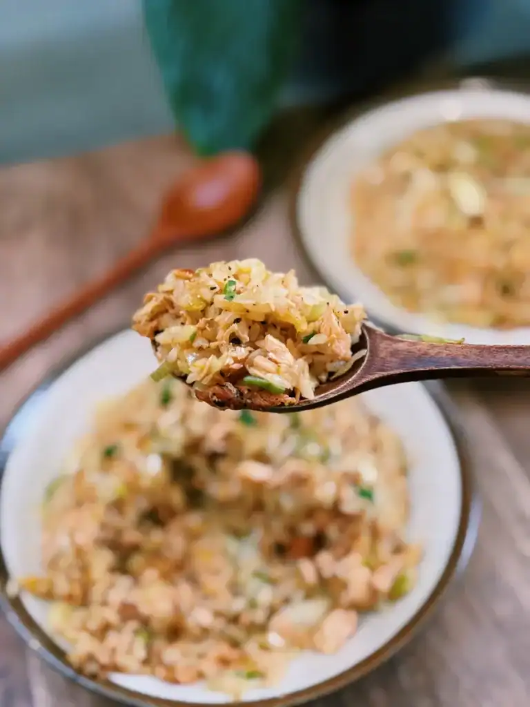 A closeup scoop of Golden Salmon Fried Rice 