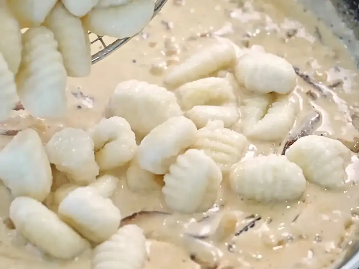 Add freshly cooked gnocchi into mushroom cream sauce for Creamy Mushroom Gnocchi