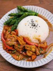 One Pot Jumbo Prawn Coconut Curry served on a plate with veggies and rice