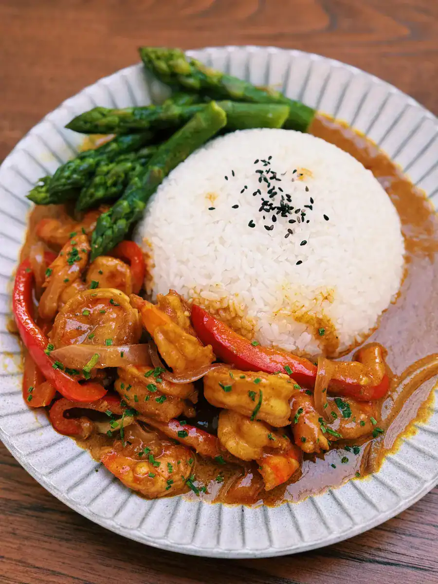 One Pot Jumbo Prawn Coconut Curry served on a plate with veggies and rice