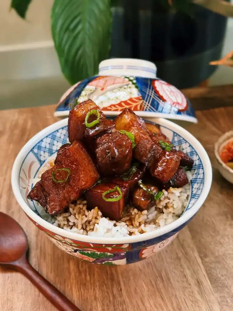 Scallion Soy Braised Pork Belly Served on top of Rice in a bowl
