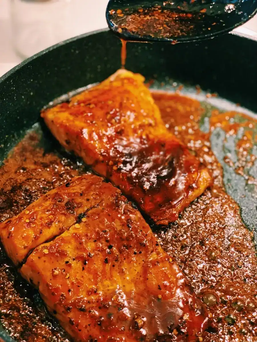 Drizzling Spicy Honey Glazed over Pan Fired Salmon to make Spicy Honey Glazed Salmon