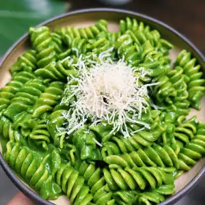 A Plate Full of Bright Green Nut Free Creamy Spinach Kale High Protein Pesto Pasta