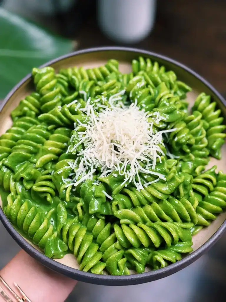 A Plate Full of Bright Green Nut Free Creamy Spinach Kale High Protein Pesto Pasta