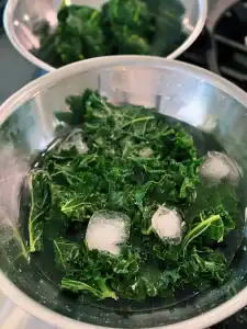 Putting kale and spinach in an ice bath to prevent oxidation for bright green High Protein Pesto