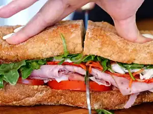 Slicing Italian Cold Cut Sandwiches in half