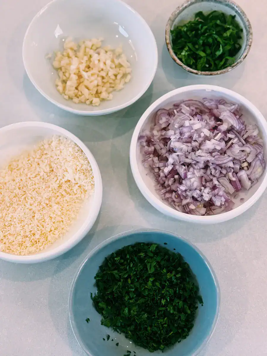 Chopped parsley, garlic, shallots, and shredded Parmesan cheese for Spicy Chili Oil Vodka Pasta