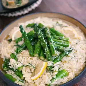 Creamy Lemon Orzo with Garlic Asparagus served with fresh Lemon Wedges