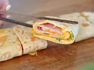 A ham and cheese Taiwanese-inspired Breakfast Wrap
