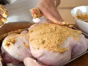 Buttering the chicken for Roast Chicken dinner in the oven