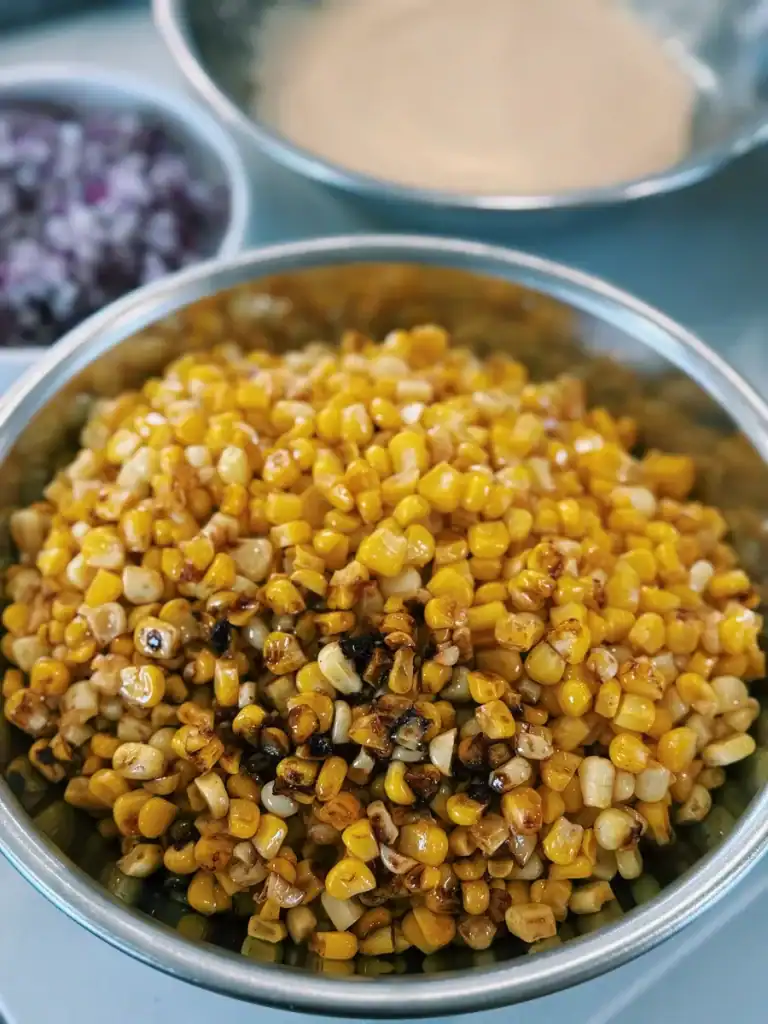 A bowl of smoky buttered corn for creamy corn chicken salad.