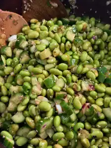 Mixing edamame chopped salad, which include edamame, cucumber, and red and green onions and yuzu sesame dressing from Kai dong