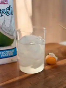 A glass of coconut water with ice for Coconut Matcha Cloud
