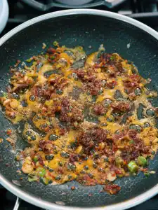 Cooking crispy bacon bits for 10 Minute Spicy Creamy Bacon Udon