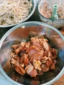 Ingredients for Spicy Thai Basil Chicken Noodle Stir Fry, including marinated chicken thigh, bean sprouts, and chopped shallots, ginger, garlic, and chili