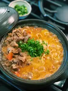 20 Minute tomato beef noodle soup, a faster version of Taiwanese Beef Noodle Soup made with fresh tomatoes and hot pot beef, garnished with green onions