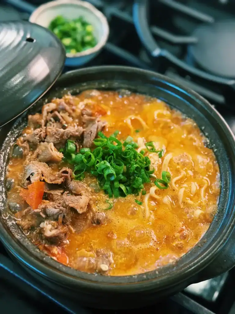 20 Minute tomato beef noodle soup, a faster version of Taiwanese Beef Noodle Soup made with fresh tomatoes and hot pot beef, garnished with green onions