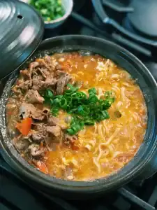 20 Minute tomato beef noodle soup, a faster version of Taiwanese Beef Noodle Soup made with fresh tomatoes and hot pot beef, garnished with green onions