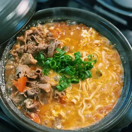 20 Minute tomato beef noodle soup, a faster version of Taiwanese Beef Noodle Soup made with fresh tomatoes and hot pot beef, garnished with green onions