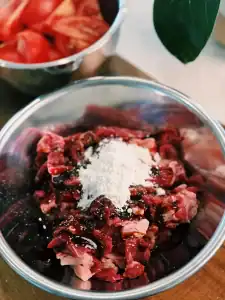 Marinating Beef Slices with seasoning and cornstarch for velvety beef in Tomato Egg Stir Fry with Beef