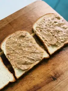 Putting peanut butter on milk bread for Hong Kong Style French Toast