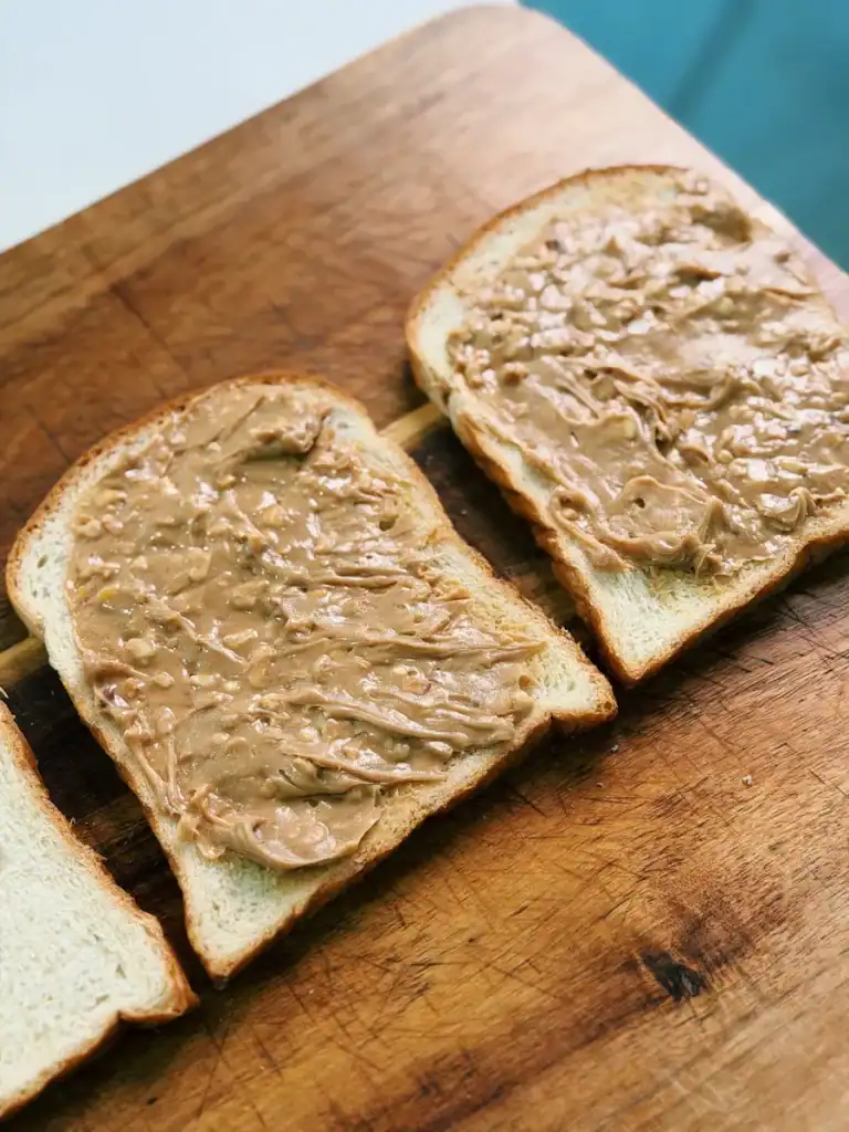 Putting peanut butter on milk bread for Hong Kong Style French Toast