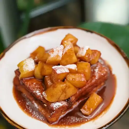 Hong Kong Style Cinnamon Apple French Toast, topped with powdered sugar