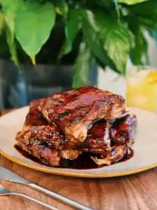 Hawaiian Pineapple Ginger BBQ Ribs stacked in a pile on a plate