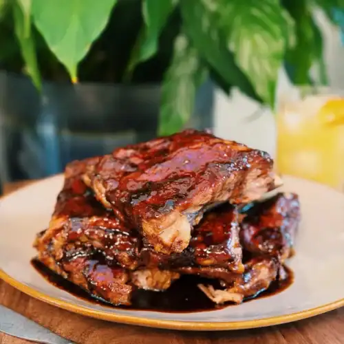 Hawaiian Pineapple Ginger BBQ Ribs stacked in a pile on a plate