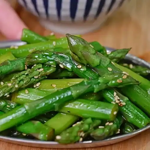 Miso Yuzu Asparagus served in dish.