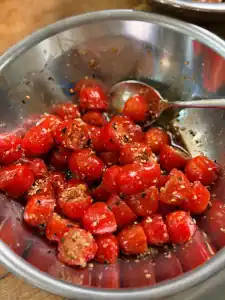 Mixing roasted sesame seeds, yuzu sesame dressing from kai dong, and furikake for Sesame Yuzu Tomato Salad