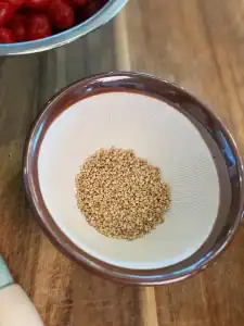 Roasted sesame seeds ready to grind for Sesame Yuzu Cherry Tomato Salad