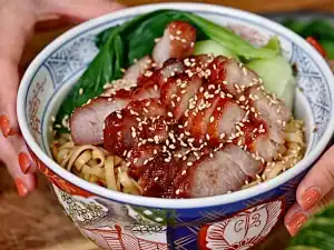 A bowl of BBQ Pork Lo Mein with Bok choy, Air Fryer BBQ Pork, and sweet-savory dried mixed noodles