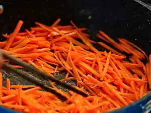 In the pan, add sliced carrots, sesame oil, and salt. Saute for 3-5 minutes, or until desired softness. Set Aside to use as a topping for braised chicken noodle soup