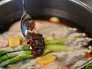 Braising liquid of chicken broth, soy sauce, Chinese cooking wine, white pepper, and Golden Shallot Oil for Braised Chicken Noodle Soup