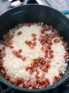 Opening the lid after cooking and steaming rice with salted meat for Shanghai Cai Fan