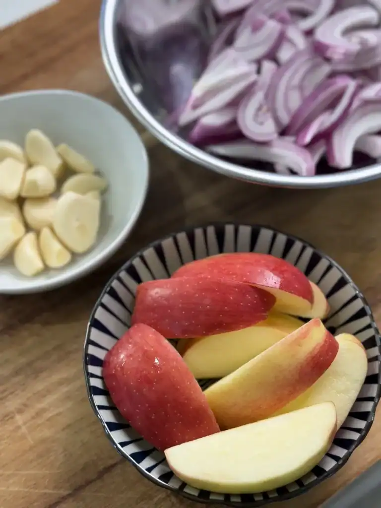 Apples, garlic, and onions prepared for Soy Glazed Apple Chicken
