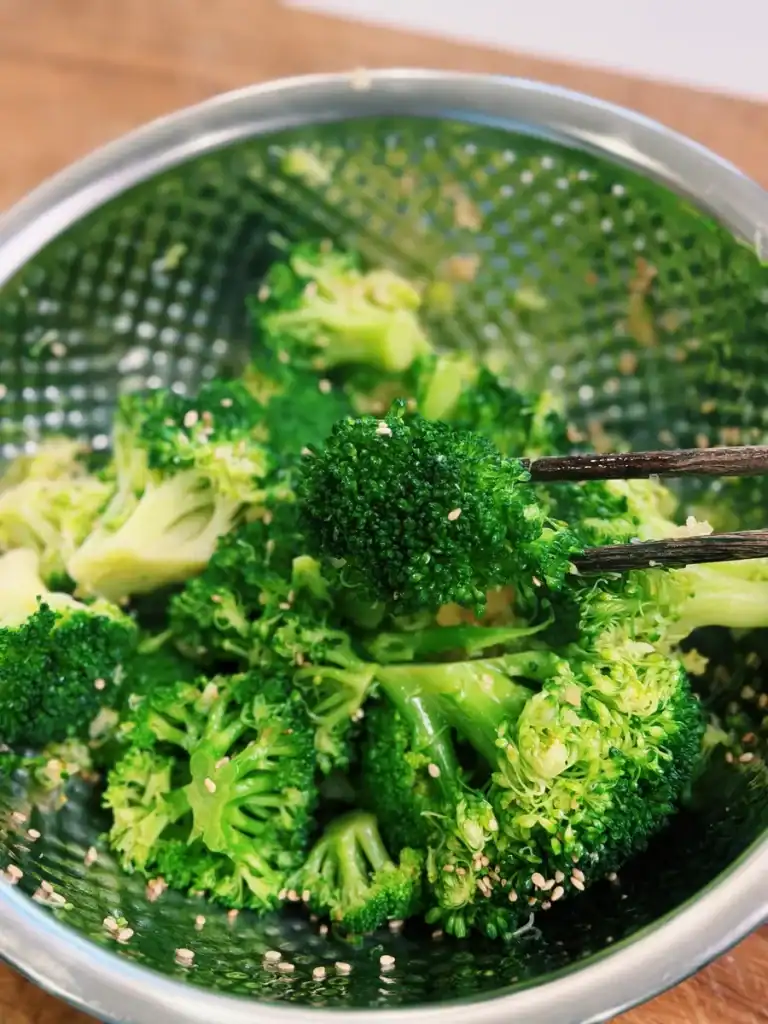 A close up of Korean Broccoli Namul seasoned with salt and minced garlic