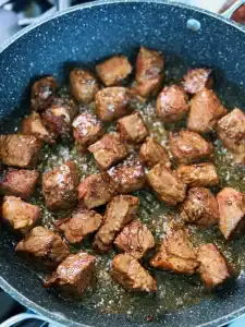Browning Steak Bites in a pan for Garlic Pineapple Steak Bites