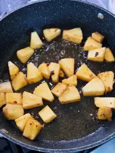 Sauteing pineapples for Pineapple Garlic Steak Bites