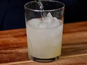 Adding soju into Pineapple Soju Cocktail