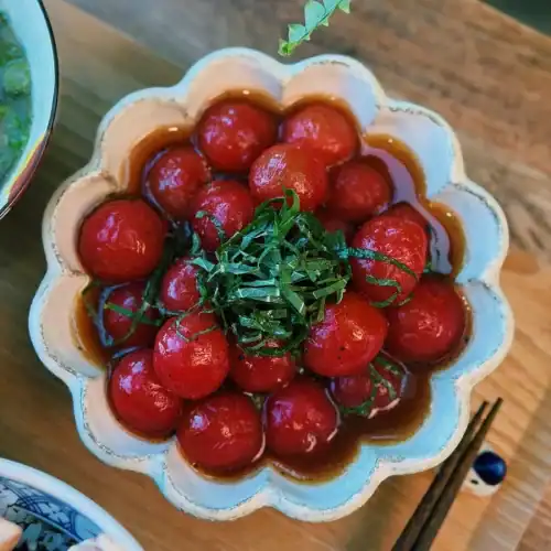 A dish of marinated Japanese Tomato Salad garnished with chopped shiso