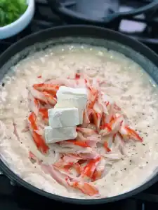 Adding imitation crab and cream cheese to crab Rangoon fillings